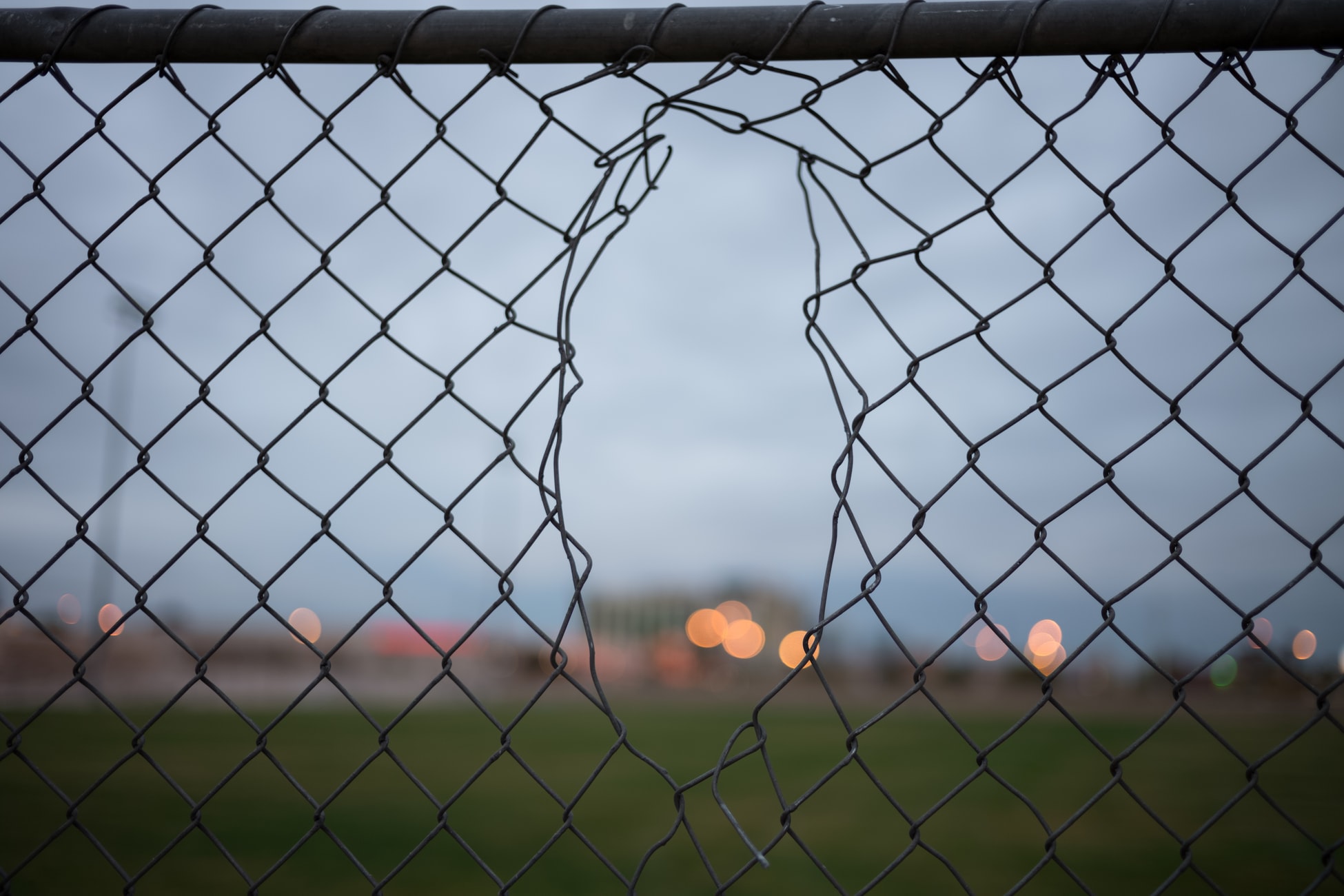 A broken chain link fence creates security vulnerabilities